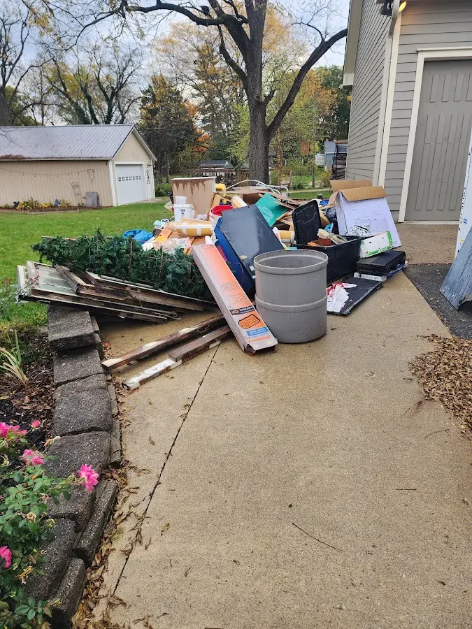 Dumpster being loaded with debris for Commercial Dumpster Rental in Highland